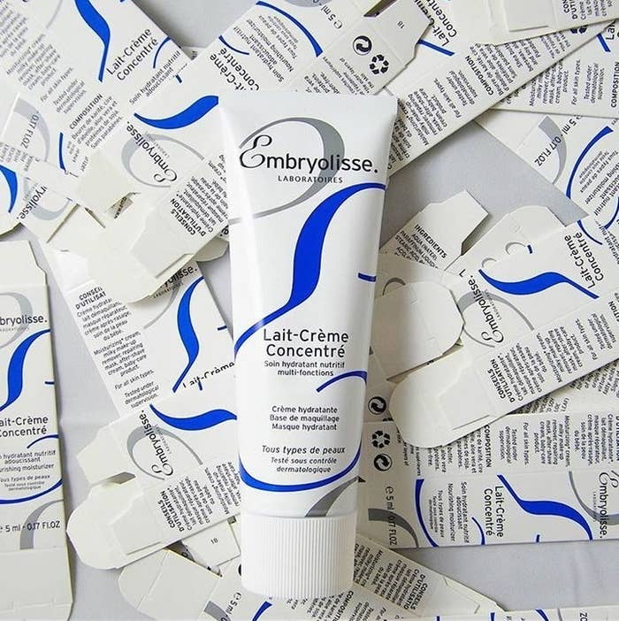 A tube of moisturizer lying on a bunch of small folded boxes