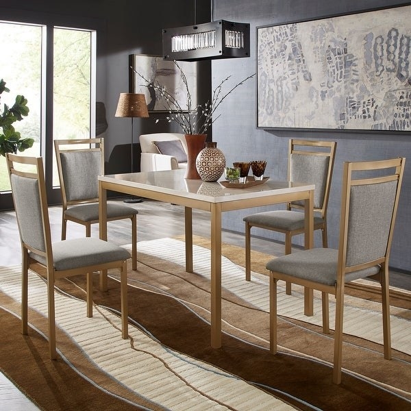 modern rectangular dining table with white faux marble top, wood base and legs. four matching dining room chairs with gray linen cushions and backs