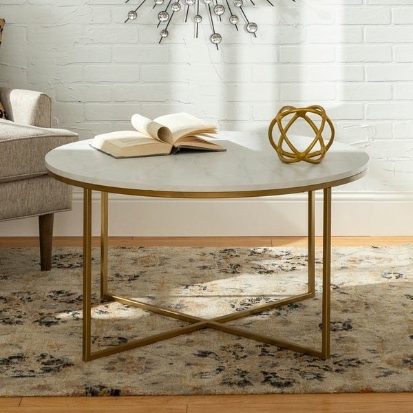 round coffee table with brass-tone legs and a white faux-marble top