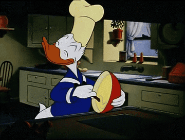 Donald Duck in a chef&#x27;s hat happily stirring batter