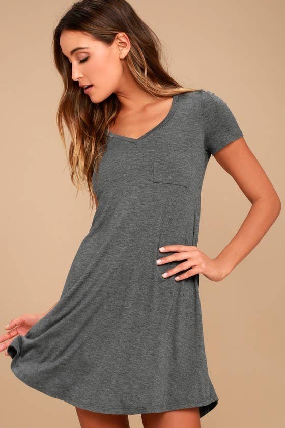 model in a grey flowy v-neck dress with a small chest pocket 