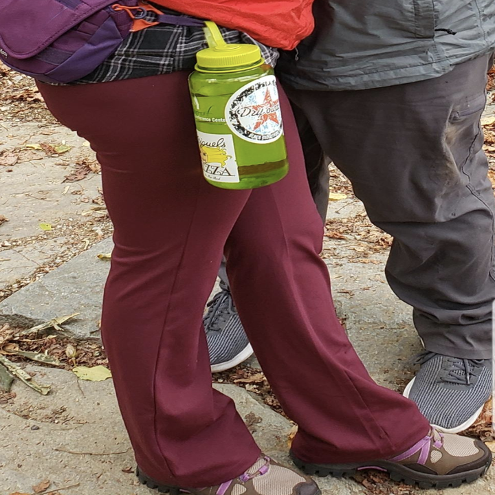 A reviewer standing outside wearing a burgundy pair with hiking boots