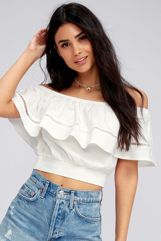 model wearing white crop top with ruffle detailing