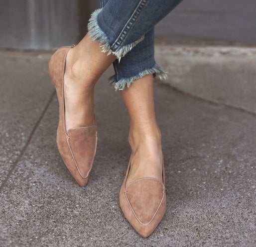feet in camel-colored pointed loafers with vegan suede fabric 