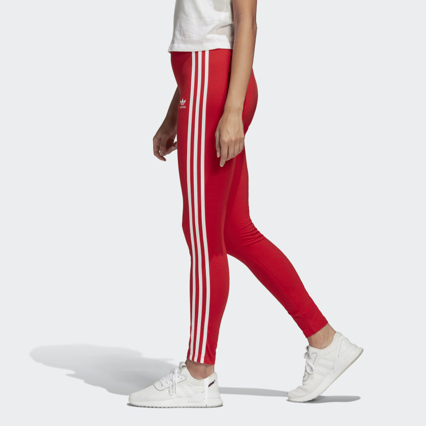 Red tights with three signature white stripes running down leg of person in motion