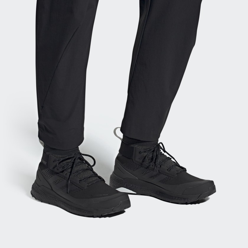 All-black hiking shoes paired with monochromatic socks and pants on model