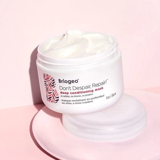 An open jar of the hair mask to show its light, creamy texture