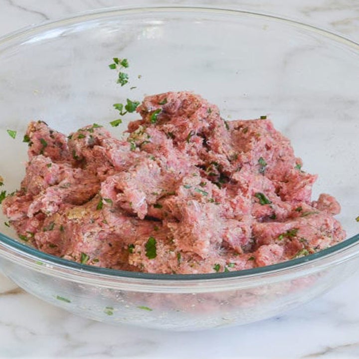 Ground meat in a bowl for meatballs.