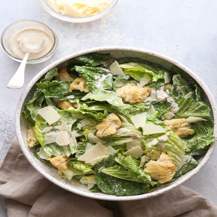 Caesar salad in a bowl with dressing.