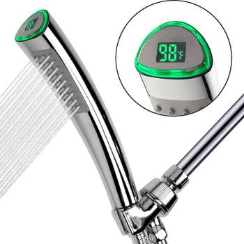 A chrome shower head with an LED display showing the temperature of the water