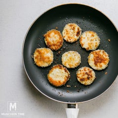Breaded eggplant cooking in a pan.