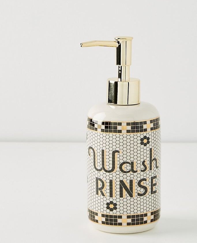 A black, gold, and white subway-tile patterned pump soap dispenser that says Wash Rinse, pictured on a white background 