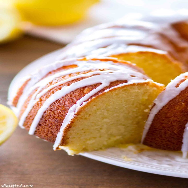 A bundt cake, sliced into, with vanilla icing.