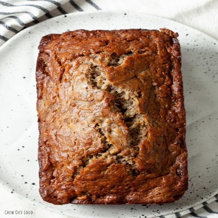 A loaf of just-baked banana bread on a plate.