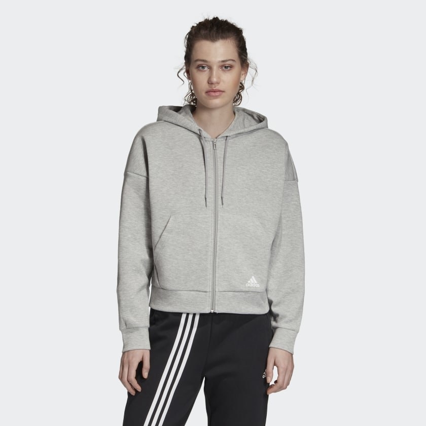 Casual fitting classic gray zip-up hoodie worn on person with track pants 