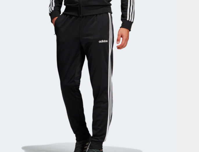 Cropped image of person wearing Adidas pants