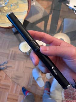 Reviewer holding the rechargeable lighter to show its full length 