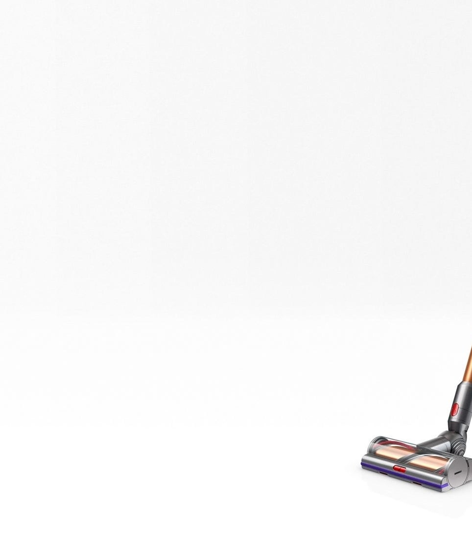 The copper colored Dyson V11 Torque Drive cordless vacuum in front of a neutral background 