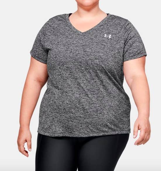 Model wearing a V-neck athletic shirt in gray