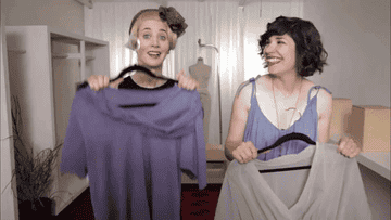 gif of two actresses in the TV show &quot;portlandia&quot; smiling and posing with two minimalist shirts