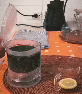 Gif of transparent teapot dispensing tea from the bottom into a glass cup