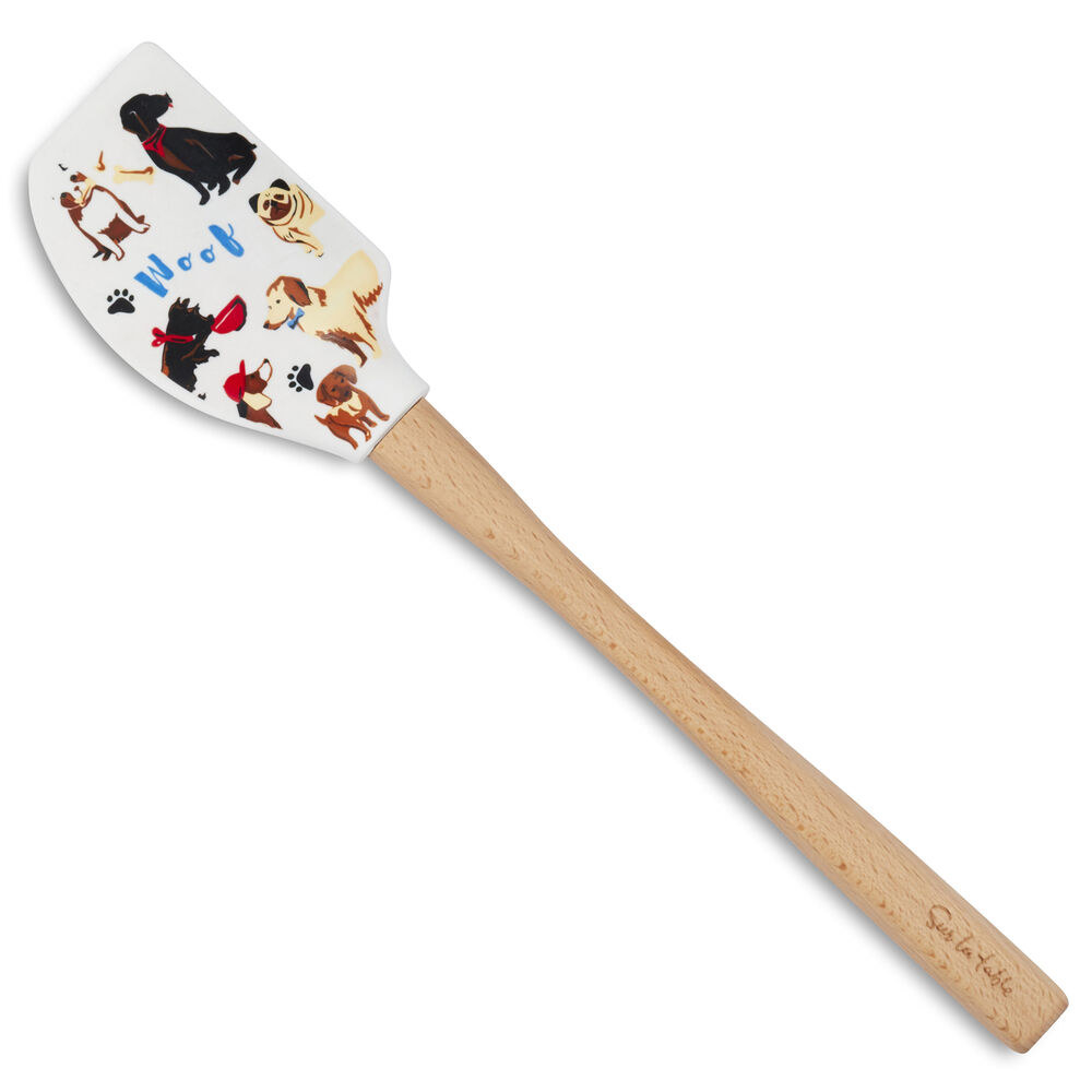 A wood and silicone spatula with various dog breeds, including a pug, a lab, and a Scottie, and the word &quot;woof&quot; printed on the silicone part