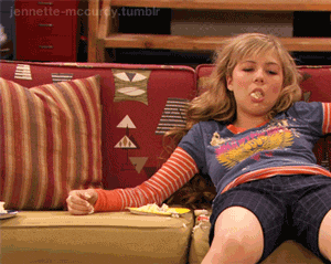 Sam from the Nickelodeon show "iCarly" slumps down on a couch with food in her open mouth