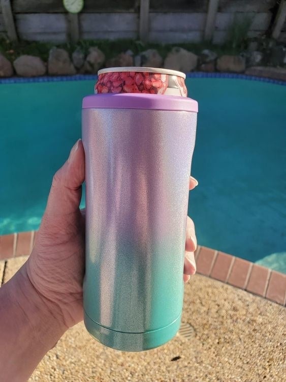 Another reviewer holding the sparkly can cooler but in a pink and blue gradient pattern