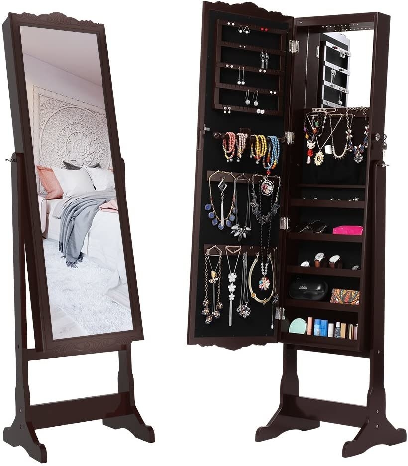 product shot of brown standing mirror that opens up to reveal a jewelry storage cabinet inside with an organized display of jewelry