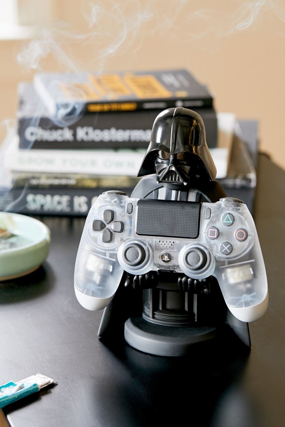 The Darth Vader-shaped device stand holding a game controller