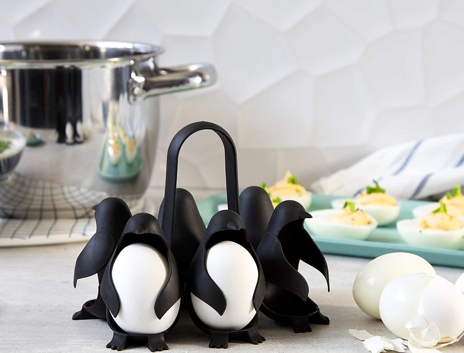 The egg holder, which looks six little penguins connected by a handle