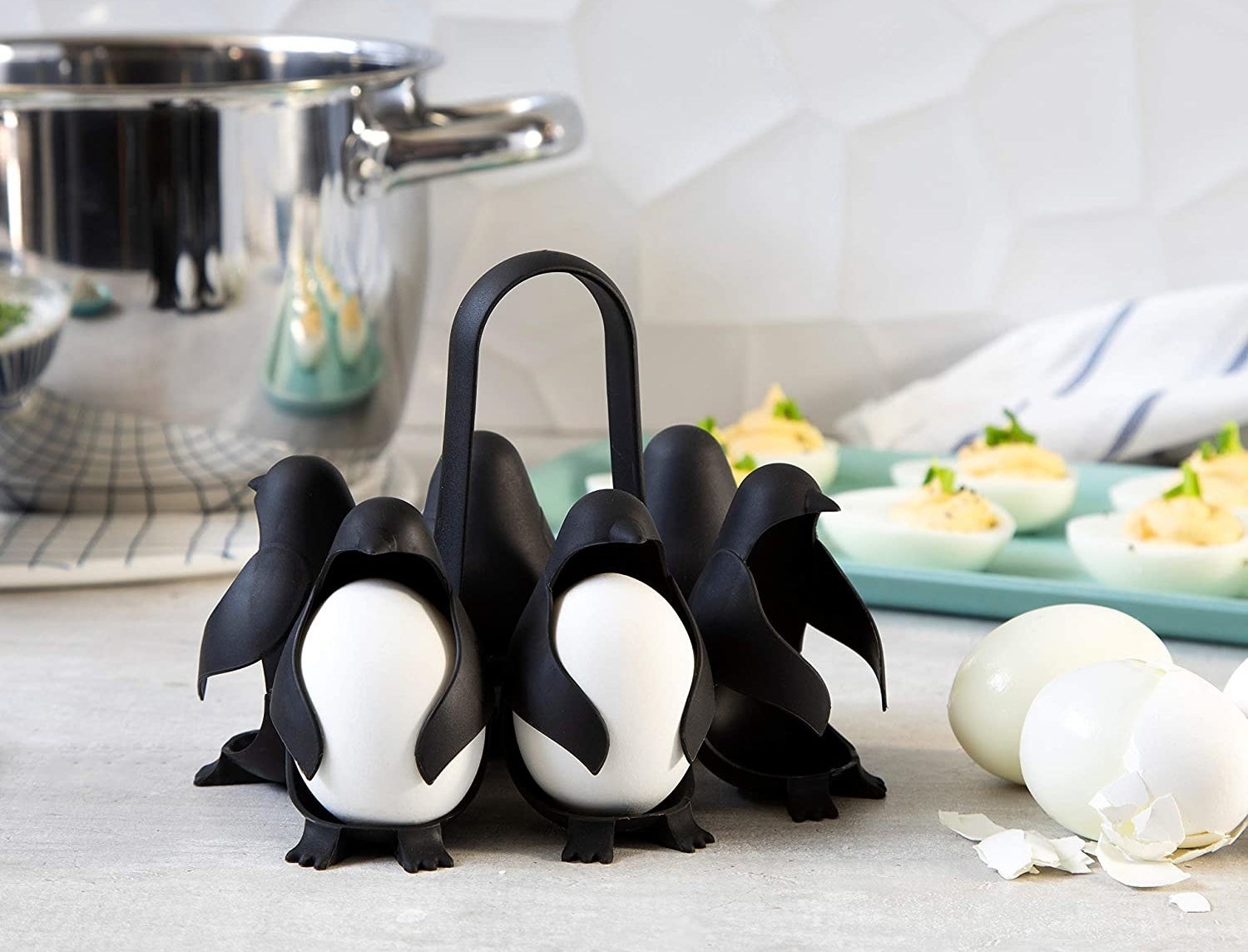 The egg holder, which looks six little penguins connected by a handle