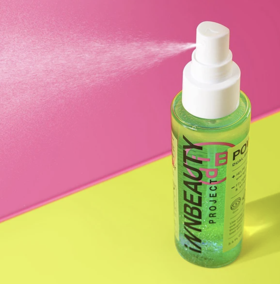 A clear bottle that says &quot;INN Beauty Project Power Up Dual-Phase Face Mist&quot; in front of a pink background
