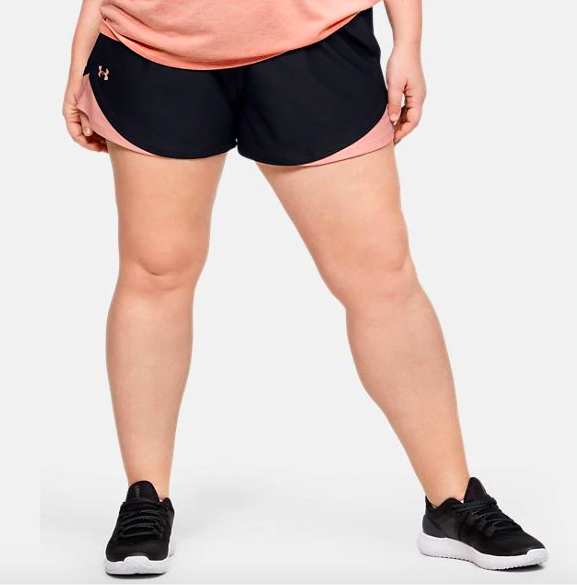 Woman wearing training shorts in black and pink colorway
