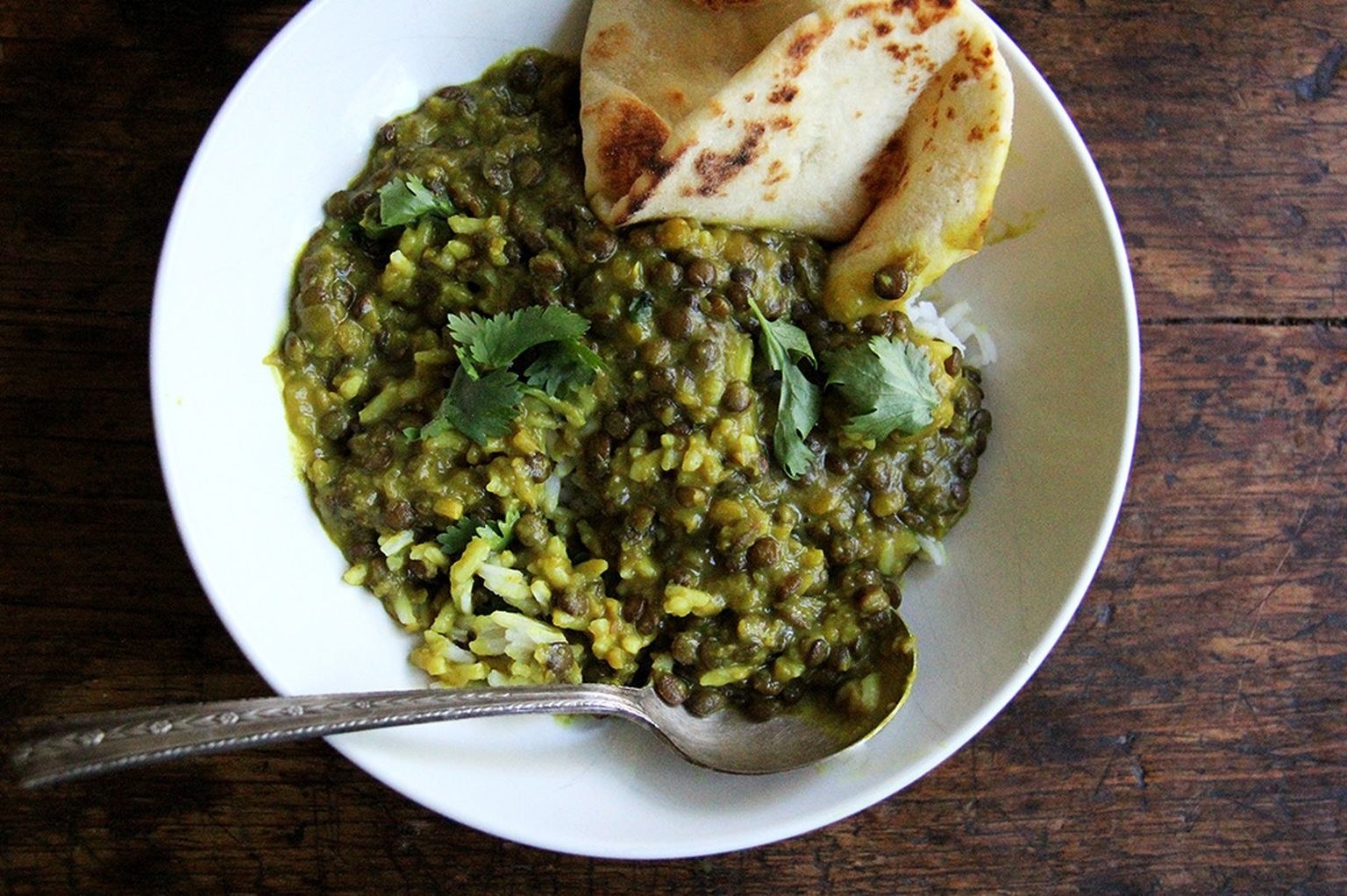 Curried lentils in a bowl with naan
