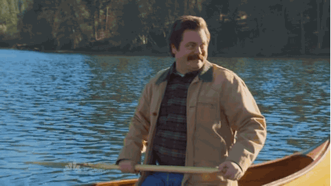 Ron Swanson from Parks and Recreation paddling in a canoe