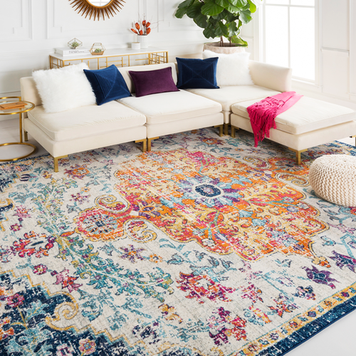 The orange, pink, and blue Bodrum area rug that covers most of the room's floor
