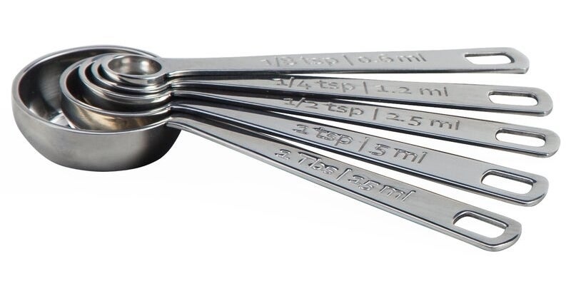 A set of five stainless-steel measuring spoons stacked within each other and fanned out to show the measurements on each handle