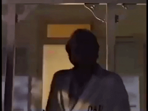 Gif of man smiling and wearing bathrobe that says DAD on it