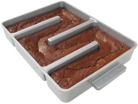 product shot of brownie pan with three dividers that jut out from the sides to the middle so that every piece of brownie has a crispy edge after baking