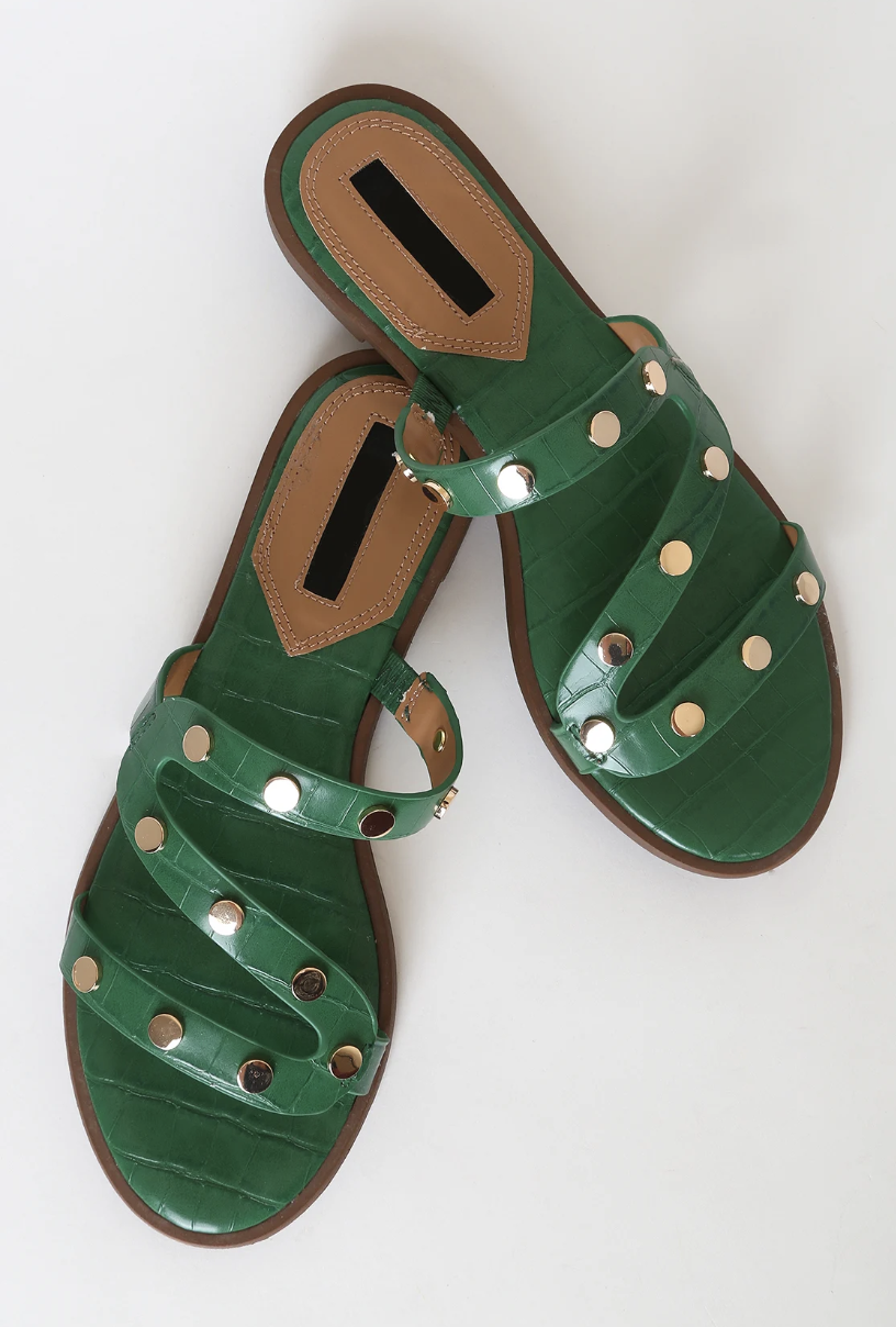 Forest green sandals with brown trim and silver rhinestones dotted across the straps that zig-zag along the front