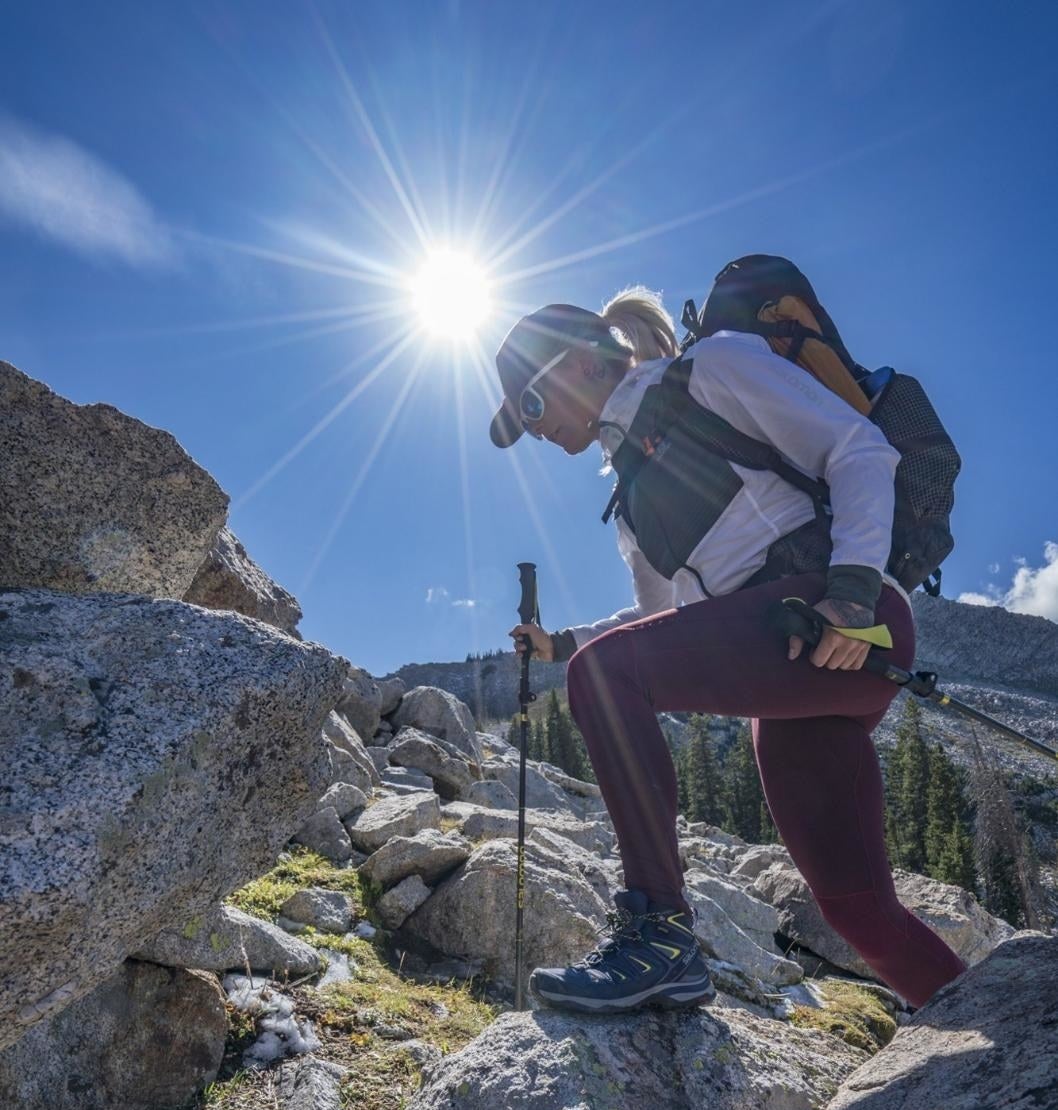 A hiker wearing the boots on rocky terrain