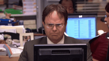 Dwight from the office looking at computer screen, visibly upset.