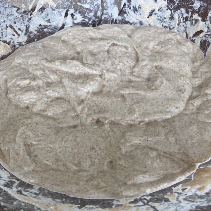A smooth blob of dough in a mixing bowl.