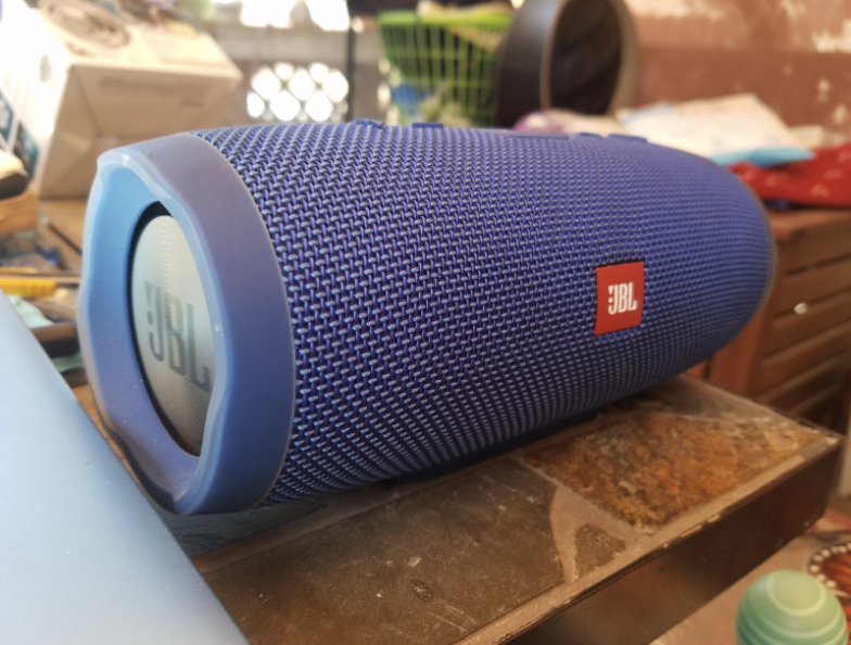 a royal blue tube-like speaker sitting on top a counter