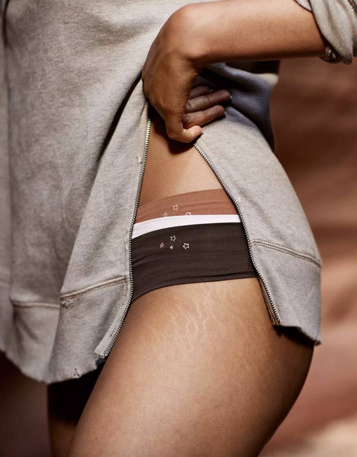 A close-up of a model's thigh showing a side-view of the low-rise thong