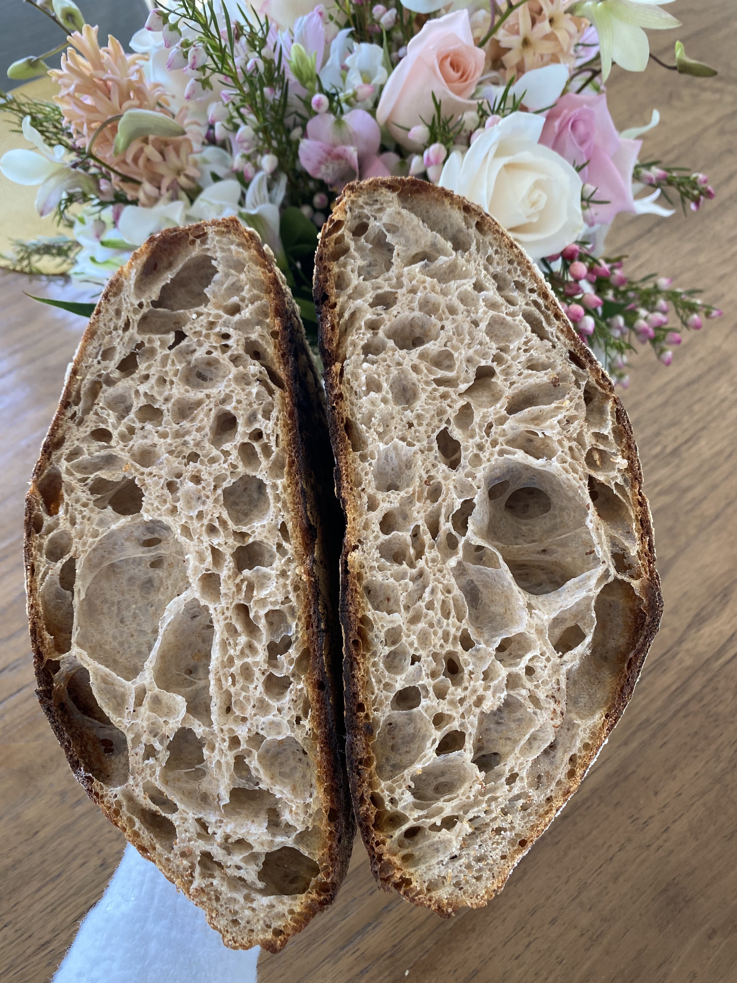 A crumb shot of a loaf of sourdough with lots of air holes.