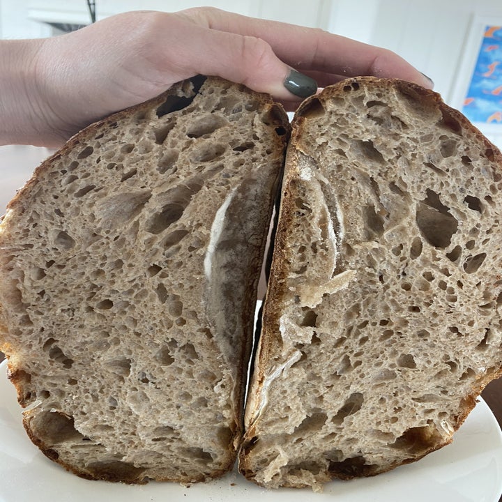 A crumb shot of a just sliced loaf of sourdough bread.