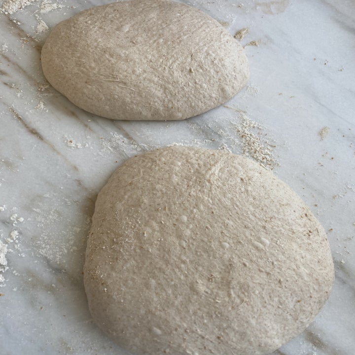 Two balls of dough on a countertop.