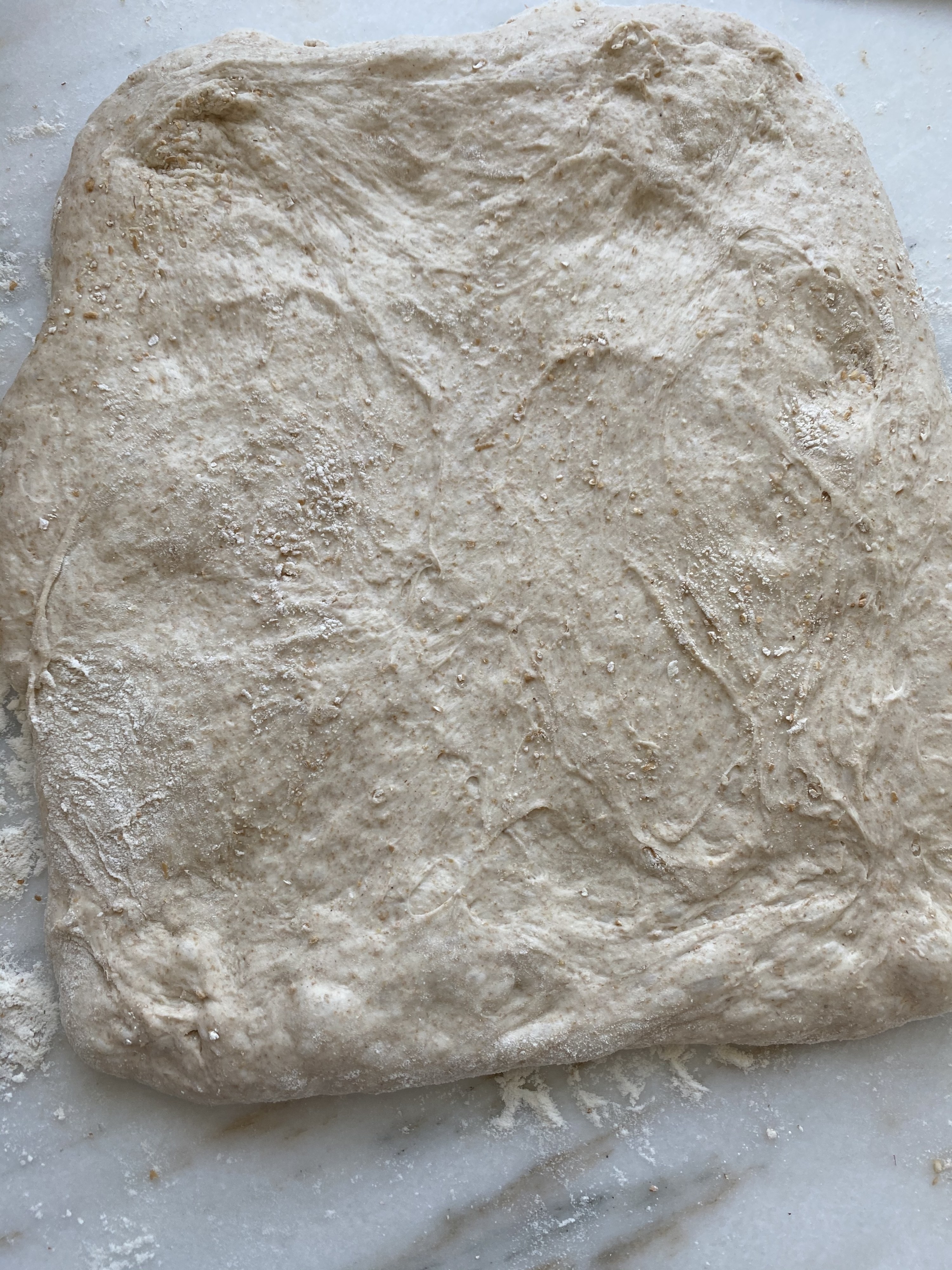 Dough shaped into a square on the countertop.